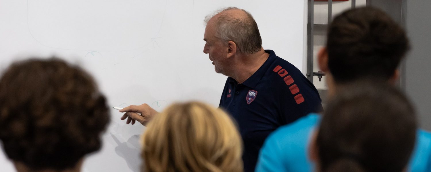 Guy delivering instructions to the youth players